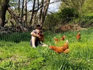 image of cameron posing with his started pullets. 